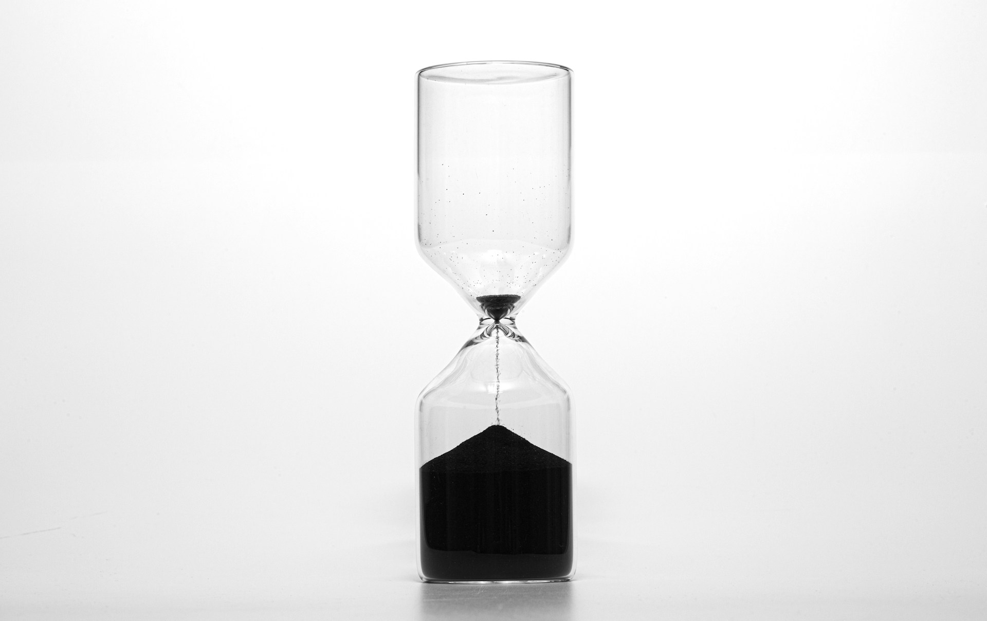 An hourglass, where there is very little sand left in the top.  Photo by  Wilhelm Gunkel on Unsplash