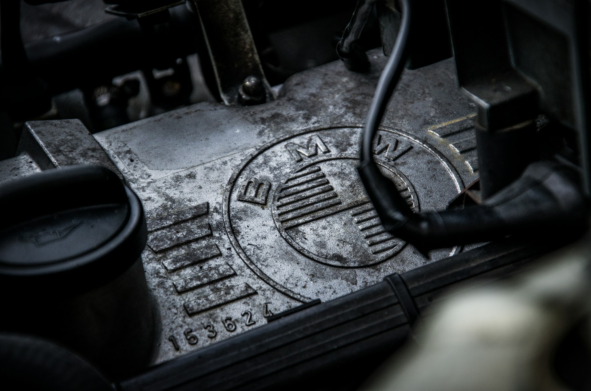 A close-up of a dirty BMW engine. Photo by Frank Albrecht on Unsplash.