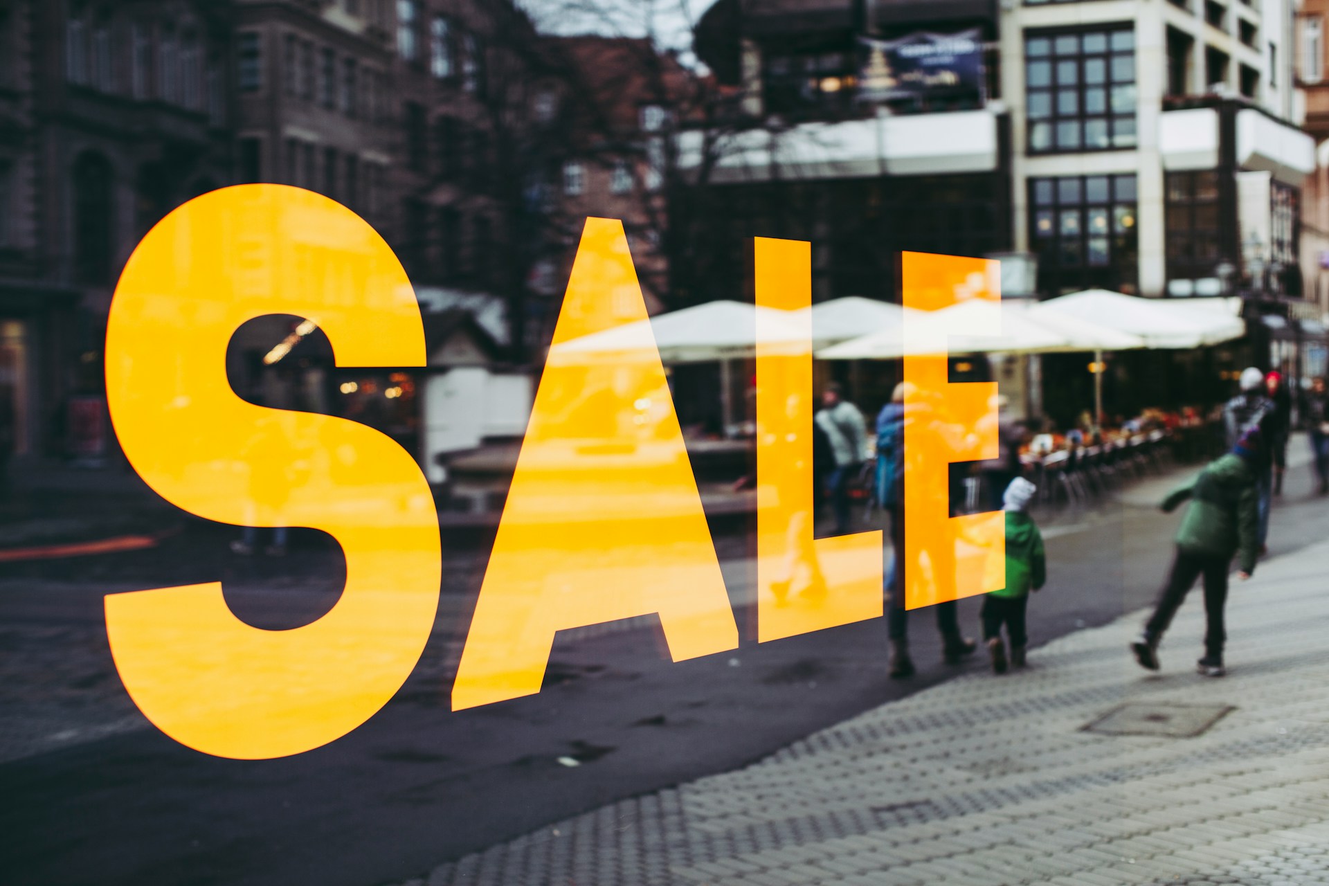 A store window with the word 'SALE'.  Photo by Markus Spiske on Unsplash.