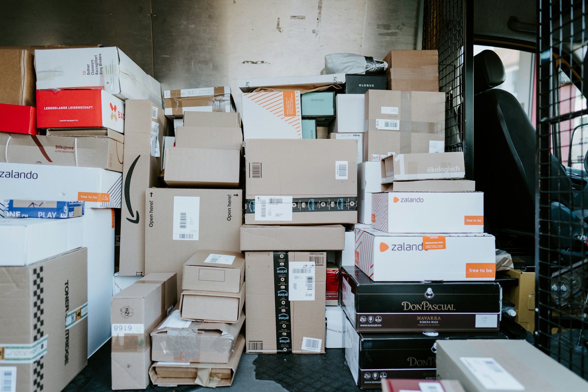 A delivery truck full of packages.  Photo by Claudio Schwarz on Unsplash