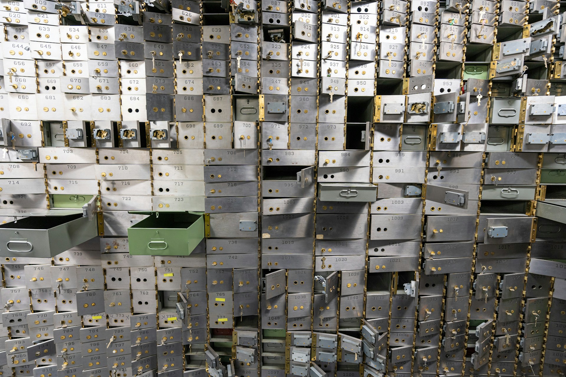 Empty bank vault safe deposit boxes. Photo by Jason Pofahl on Unsplash.